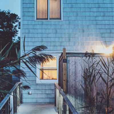 Close up of the back of a beach house in the evening.